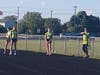 Girls sprinters get instructions before beginning their training.