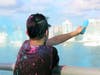 An LGBTQ activist pours colored corn starch from the Ringling Causeway Bridge Saturday.
