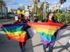 Grace Korley, left, and Shannon Fortner with the Harvey Milk Festival participate in Saturday's march across the Ringling Causeway Bridge.