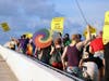 About 60 protestors marched across the Ringling Causeway Bridge in Sarasota Saturday.