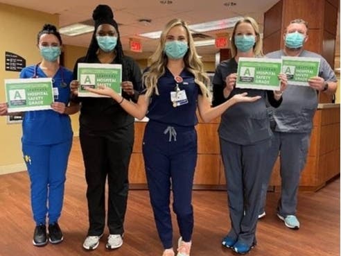Caregivers from the COVID-19 unit at Doctors Hospital of Sarasota celebrate earning “A” grade for safety.