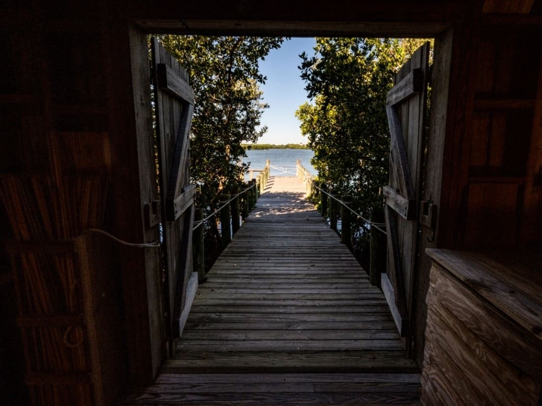 A view through the historic Packing House to the dock where Selby Gardens by Boat tours will arrive at the Historic Spanish Point campus.