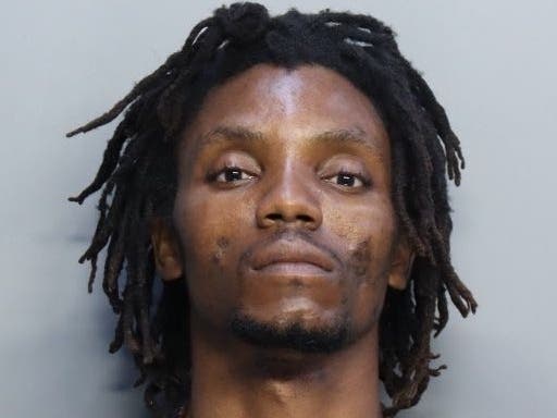Two men were shot and injured by a coworker at a Miami International Airport cargo warehouse Tuesday, Miami-Dade police said. Jackson Entienne, pictured, faces multiple charges.