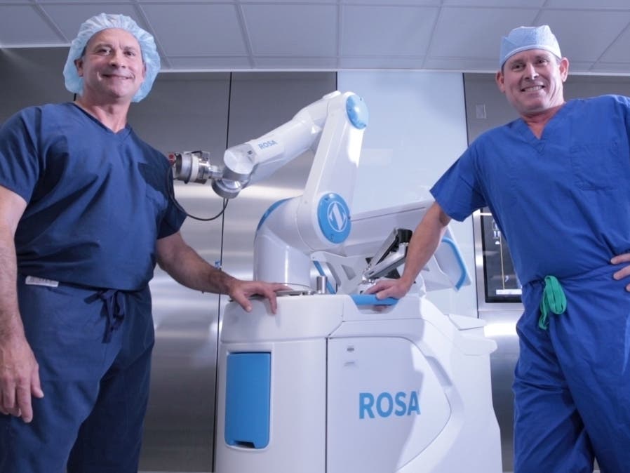 Orthopedic surgeons Dr. Edward Stolarski, left, and Dr. Sean Dingle, lead Sarasota Memorial Hospital’s robotic surgery team. They were among the first in FL to use ROSA. Stolarski will perform the first robotic-assisted hip replacement later this month.