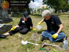 Florida Public Archaeology Network volunteers clean a gravestone during a historic cemetery preservation event in South Florida.