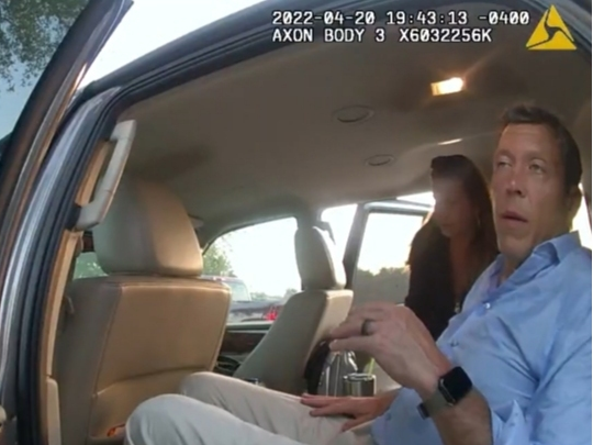 Manatee County Commissioner George Kruse speaks to a Manatee County Sheriff's Office deputy after crashing his truck into a tree near his Bradenton home in April. Kruse faces a DUI charge.