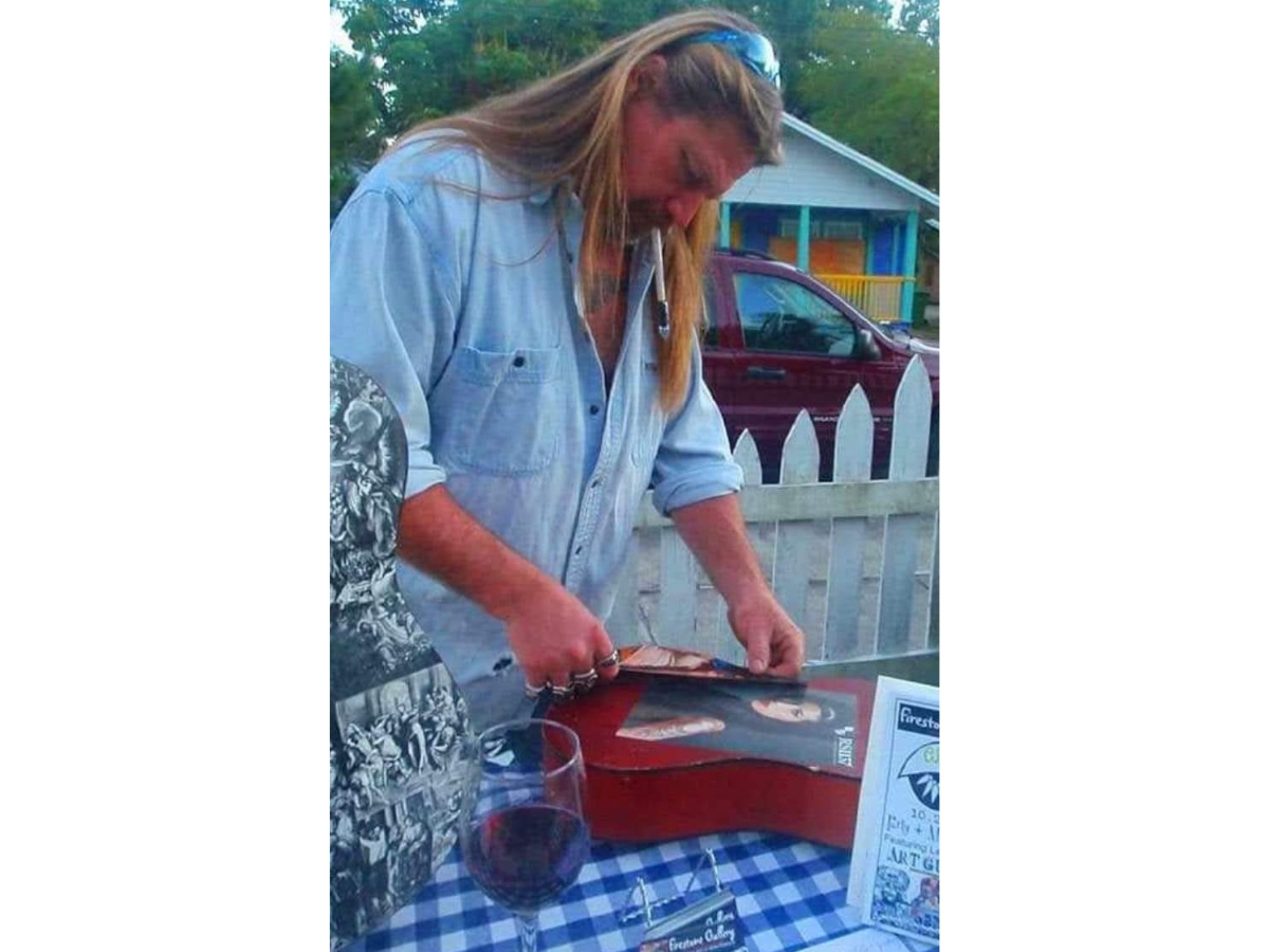 A showcase of upcycled guitar art in Bradenton's Village of the Arts pays tribute to the late artist Lee Firestone, a Waste Pro worker killed on the job.