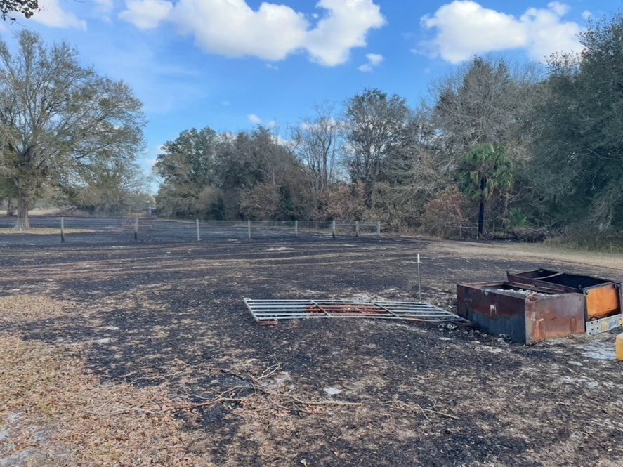 A Polk County teacher was arrested for burning debris in his yard and cursing a 5-acre brush fire despite a burn ban, the sheriff’s office said.