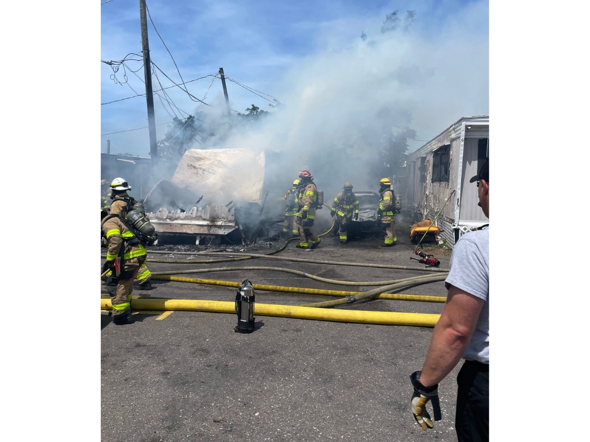 Firefighters battling a house fire have shut down a busy Tampa intersection, Florida Highway Patrol said.