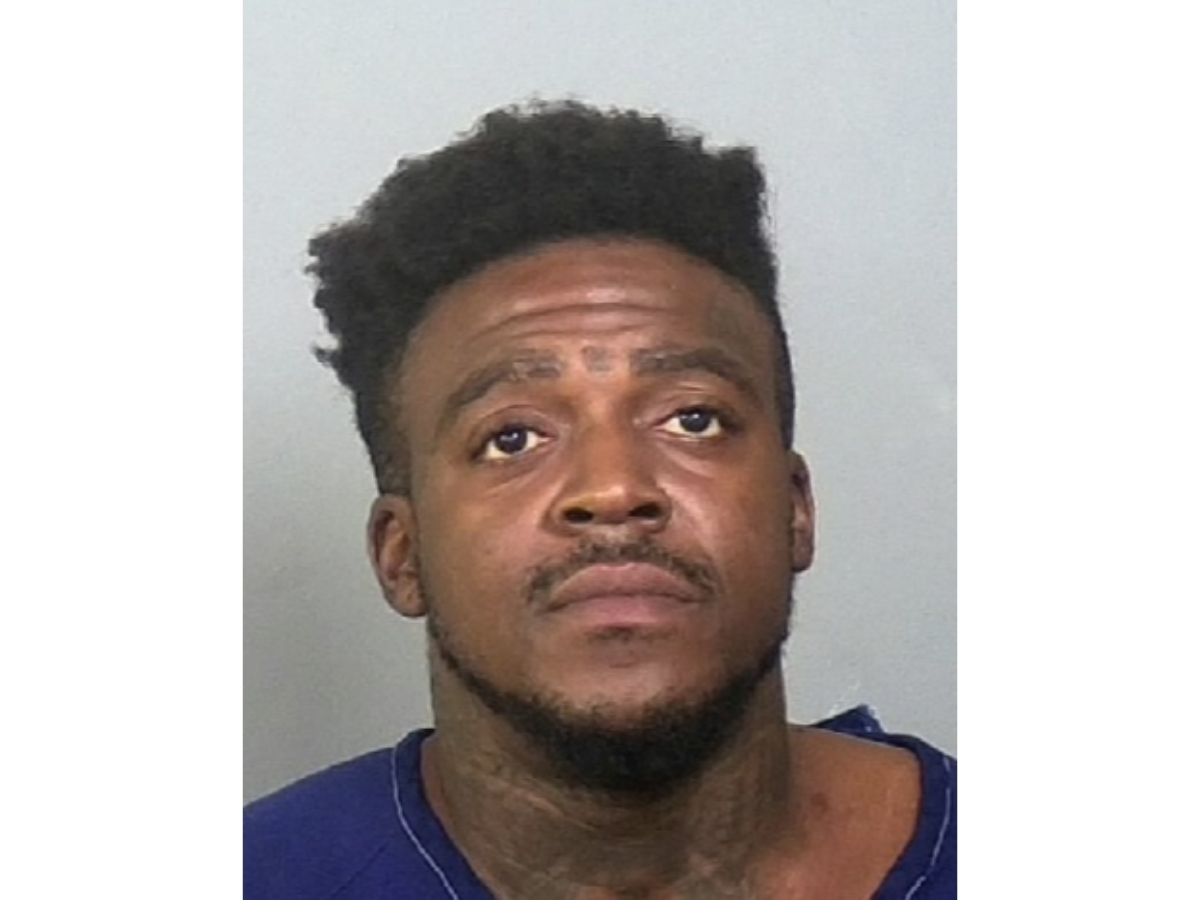 A man already jailed for drug-related charges was charged with murder in the fatal shooting of two men in Bradenton, police said.