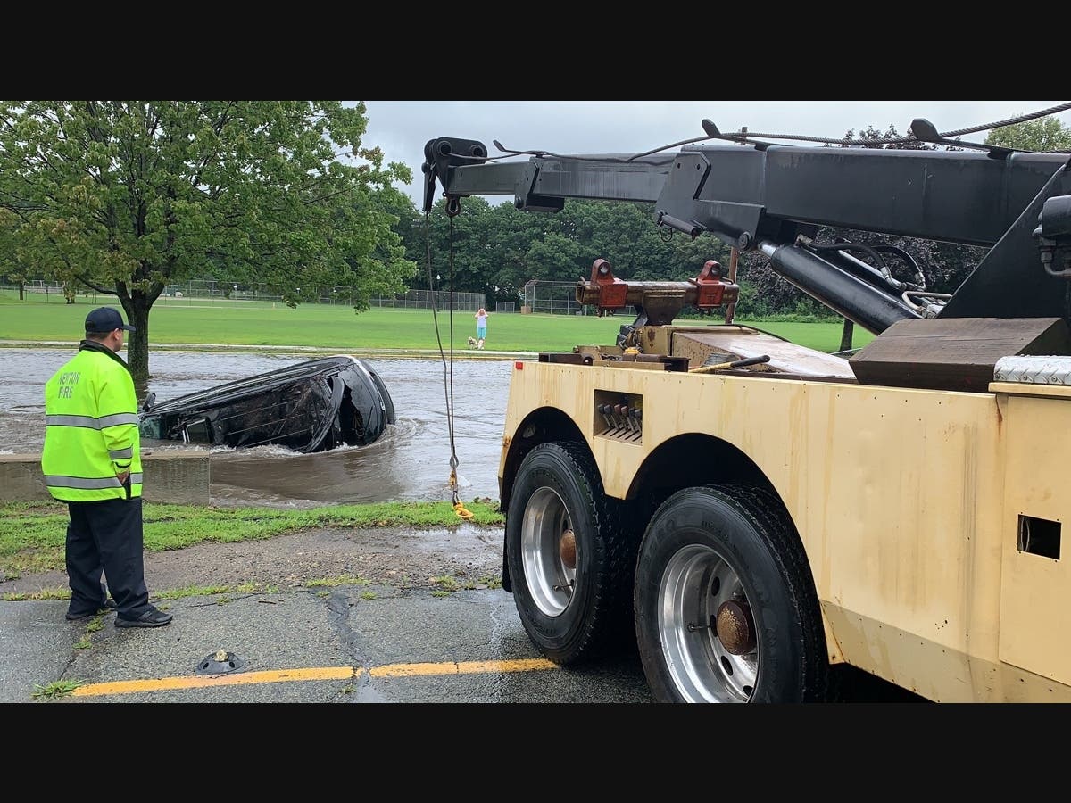 A car was swept into Cheesecake Brook Thursday afternoon due to flash flooding, said fire officials. 