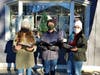 From left to right, Stephanie Charbonnier of Essex, Cooper Johnson of Deep River and Abigail Johnson, also of Deep River, spent Sunday afternoon singing holiday songs in front of their grandparents store,  Celebrations!