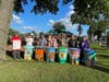 The Northern New Jersey Community Foundation’s Executive Director, Leonardo Vazquez (left), joined some of the artists posed with the rain barrels they painted on display in Carver Park in Hackensack.  