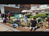 Volunteers of all ages assisted with installing plants in a community rain garden.  