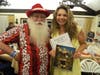 Santa Claus presenting his early gift of a photo with him