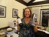 Another lucky winner of a door prize with the dessert table in the background. 