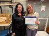 Silver Cross occupational therapist Deborah Jacob-Maas presents Cheryl Smithgall with a certificate of achievement after completing her first post-implant occupational therapy session.
