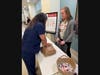 A Silver Cross staff member learns hands-only CPR outside the hospital’s dining room during an education session held on CPR Awareness Day (Aug. 5).