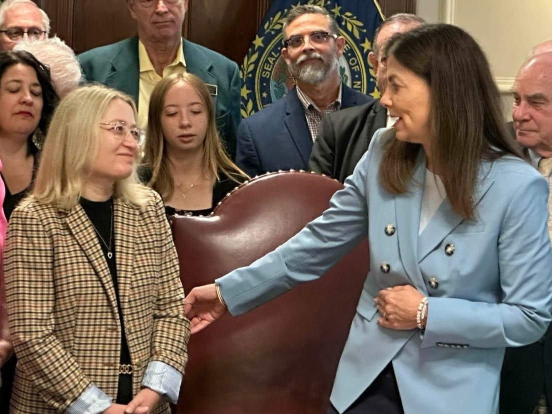 Gov. Kelly Ayotte speaks to Marika Yakubovich after signing Right To Try legislation named after her husband, Rep. Michael Yakubovich (R-Hooksett).