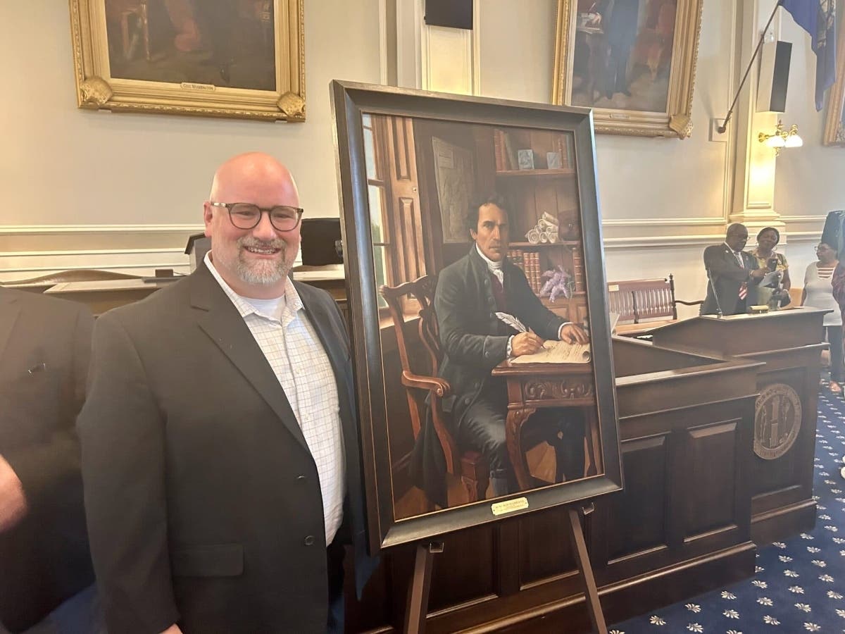 Ryan J. Flynn with his portrait of Wentworth Cheswill at the N.H. State House. 