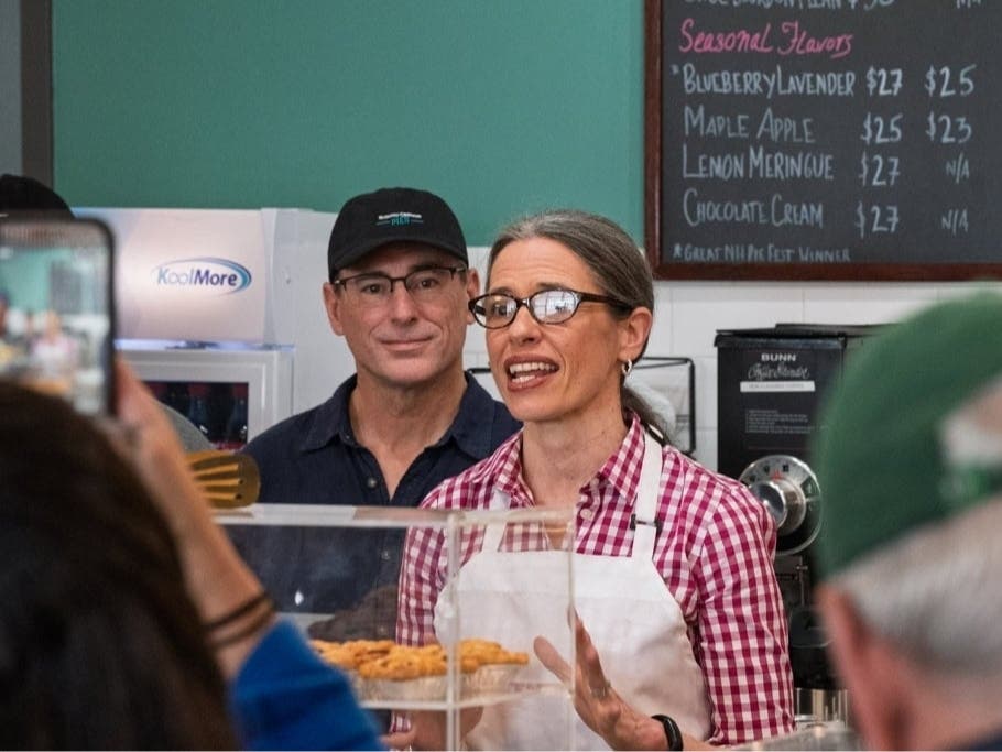 Lauren Cline welcomes customers to the grand opening of “Slightly Crooked Pies” on Elm Street in Manchester.