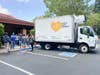 Volunteers load clothing donations into the White Pony Express truck.