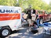 Volunteers unload clothing donations from cars at the drive-thru drop off event.