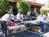 Volunteers sort, fold, and box up clothing donations for White Pony Express.