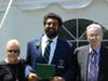 Anthony Burnett with his grandmother (left) and grandfather (right) after graduation. 