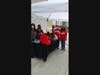 Volunteers get ready to hand out backpacks outside the Tabernacle of Emmanuel Full Gospel Assemblies.