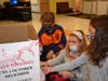 Members of Forest Lake Elementary School’s Student Council put the finishing touches on a toy collection box for the U.S. Marines Corps Reserves' Toys for Tots program. From left are: Brendan Wood, Sophia Santopietro and Ella Austin.