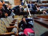 People shelter in the House gallery as protesters try to break into the House Chambers in the U.S. Capitol on Wednesday, Jan. 6, 2021, in Washington.