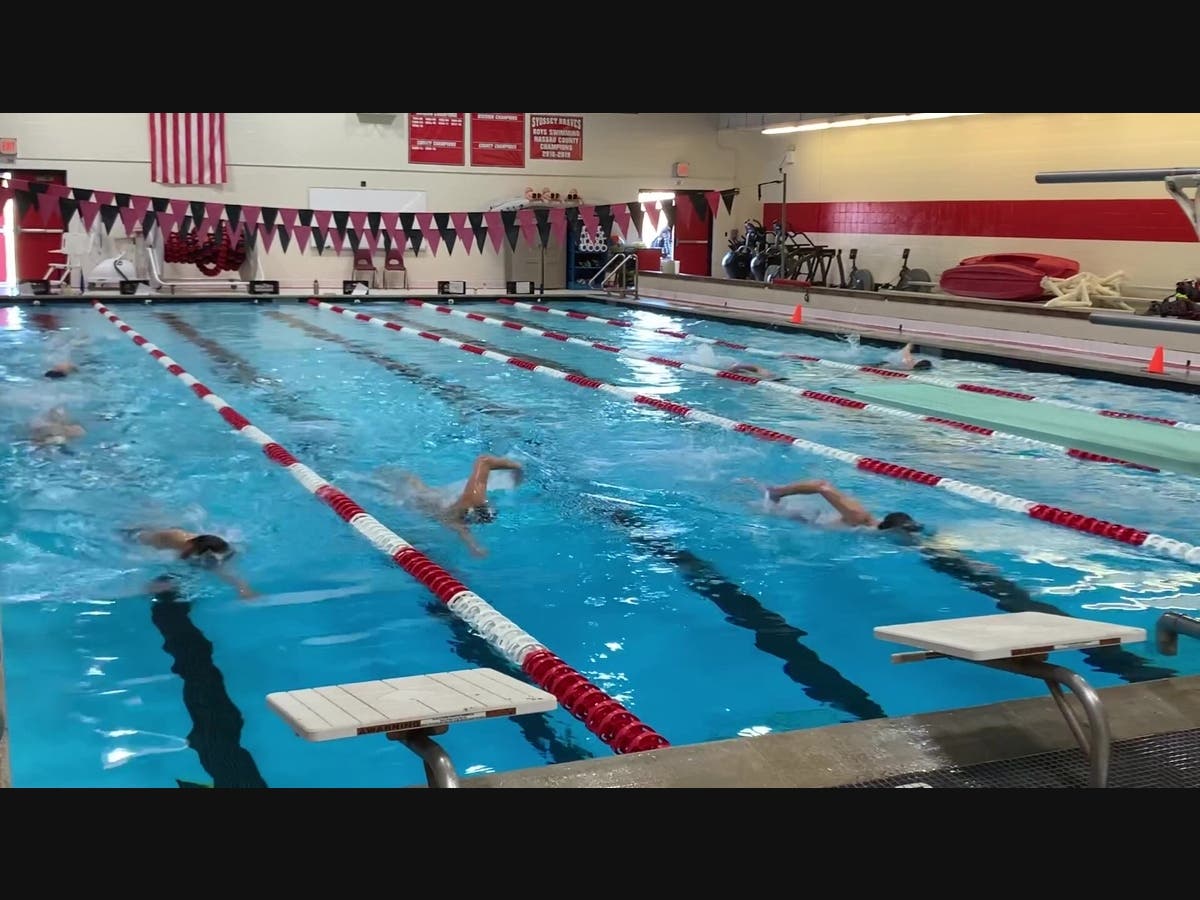 Swimmers from the Syosset Varsity Boys Swim and Dive Team practice in the Syosset Central School District pool. 