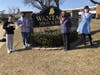 Wantagh High School seniors Michael Minars and Chris Murale, Joan Flynn of Island Harvest and The Warrior’s advisor, Kathleen Flynn, are pictured during a check-signing donation benefitting 1,000 food insecure residents in and around the Wantagh.