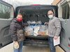 Brian Walsh and John Meisen, who are also members of the Family Residences and Essential Enterprises POD food delivery service program, pack up some grub for delivery.