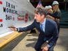 Atillio Petrocelli signs his name to the beam.