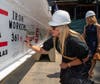 Beverly Petrocelli adds her signature to the beam.