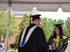 A graduate receiving her diploma from Principal William Bernhard.
