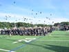 The new alumni celebrated by tossing their hats in the air.