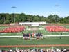 The students sat in two groups of red on the football field.