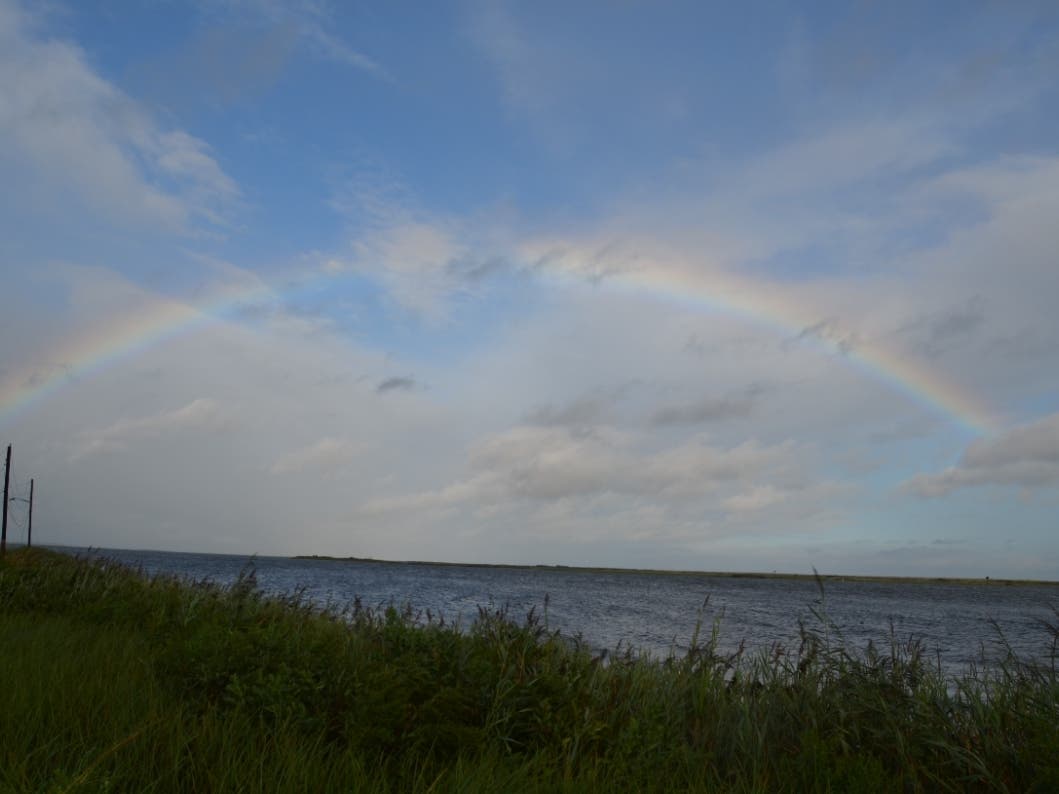 A rainbow broke through the clouds Sunday afternoon at Cranberry Dock in Mastic Beach.