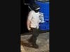 One of the men can be seen wearing a light-colored t-shirt and dark pants.