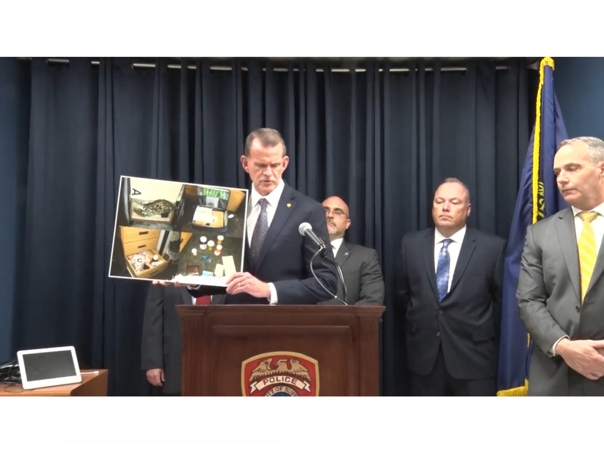 Suffolk County Police Department Acting Police Commissioner Stuart Cameron holds up a photo of items seized from a Stony Brook University student's dorm room at a news conference on Friday.
