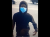 He was wearing a blue surgical mask, as was his accomplice, according to surveillance images.