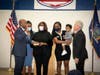 Suffolk Police Commissioner Rodney Harrison is sworn in by County Executive Steve Bellone as his family looks on.