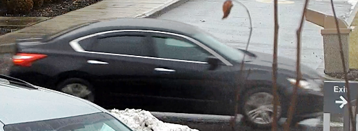 The black four-door Nissan the robber fled in. / SCPD