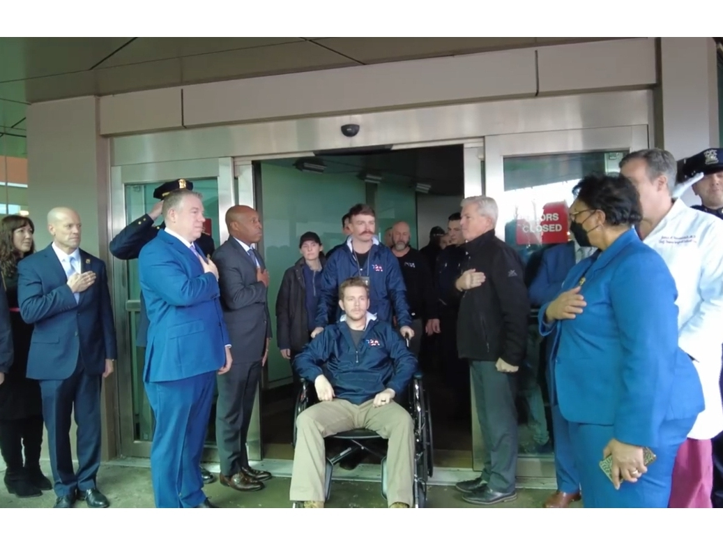 Suffolk Police Officer Raymond Stock was wheeled out of Stony Brook Hospital on Friday by his fellow Officer Brendon Gallagher.
