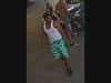 One male was wearing a white tank top and board shorts.