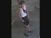Another male was wearing a white tank top and black basketball shorts.