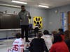 Fifth graders asking Greg Senat questions about how he began playing football in the NFL.